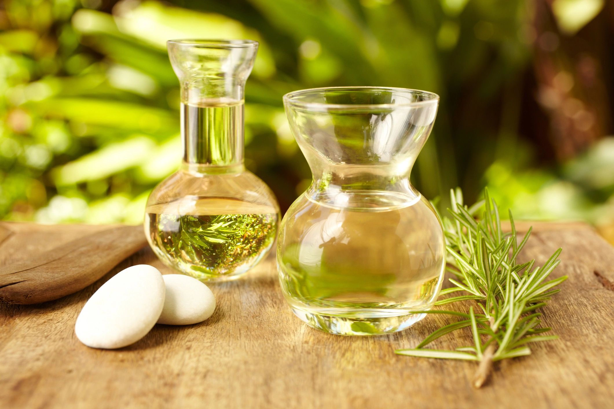 Massage oil bottles with spa stones outdoors